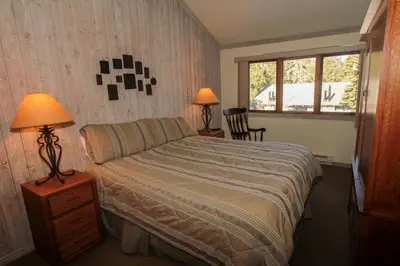 a bedroom with a bed and two lamps and a window at Mountainback 12 2 Bdrm 3 Ba Loft - Pet Ok in Mammoth Lakes