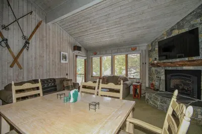a living room with a table and a fireplace at Mountainback 12 2 Bdrm 3 Ba Loft - Pet Ok in Mammoth Lakes