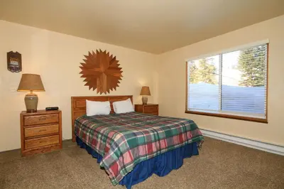 a bedroom with a bed and a large window at Discovery 4 125 in Mammoth Lakes