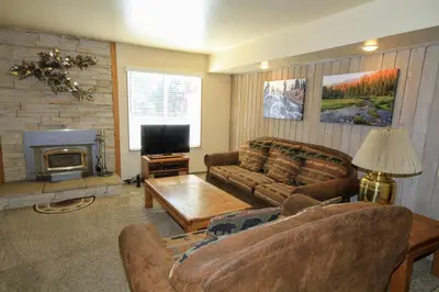 a living room with two couches and a fireplace at Discovery 4 125 in Mammoth Lakes