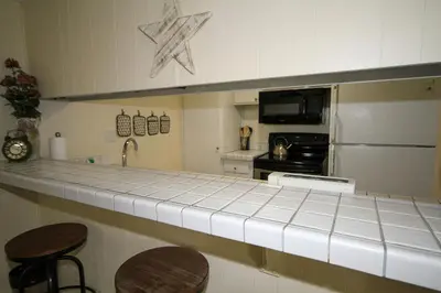 a kitchen with a counter top and a refrigerator at Discovery 4 117 in Mammoth Lakes