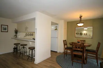 a dining room and kitchen with a table and chairs at Discovery 4 117 in Mammoth Lakes