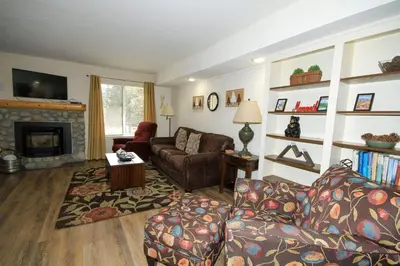 a living room with a couch and a fireplace at Discovery 4 117 in Mammoth Lakes