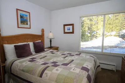 a bedroom with a bed and a large window at Discovery 4 115 in Mammoth Lakes