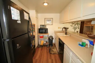 a kitchen with a black refrigerator and a sink at Discovery 4 115 in Mammoth Lakes