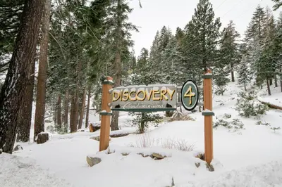a sign in the snow in a forest at Discovery 4 113 in Mammoth Lakes