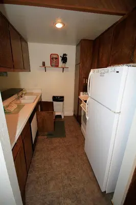 a kitchen with a white refrigerator and a sink at Horizons 4 140 1 Bedroom Loft 1 Bath in Mammoth Lakes