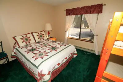 a bedroom with a bed and a window at Forest Creek 3 Pet accepted in Mammoth Lakes