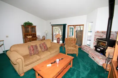 a living room with a couch and a wood stove at Forest Creek 3 Pet accepted in Mammoth Lakes