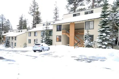 a building with a car parked in the snow at Discovery 4 152 Loft Pet Ok in Mammoth Lakes