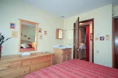a bedroom with a bed and a sink and a mirror at Discovery 4 142 Loft in Mammoth Lakes