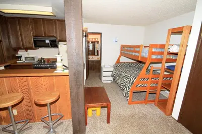 a small room with a kitchen and a bunk bed at Crestview 17 in Mammoth Lakes