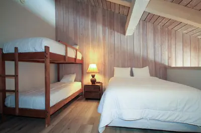 a bedroom with two bunk beds and a lamp at Mammoth Ski Racquet Club 86 - Pet Friendly in Mammoth Lakes