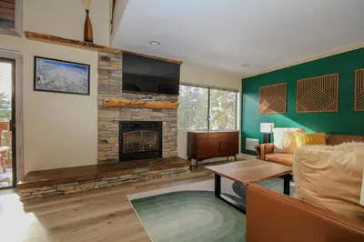 a living room with a couch and a fireplace at Mammoth Ski Racquet Club 86 - Pet Friendly in Mammoth Lakes