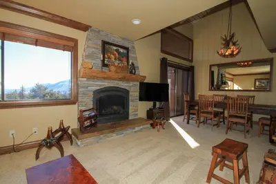 a living room with a fireplace and a dining room at Mammoth Ski Racquet Club 67 in Mammoth Lakes