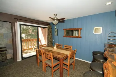 a dining room with a wooden table and chairs at Mammoth Ski Racquet Club 94 2 bedroom Dog Friendly in Mammoth Lakes