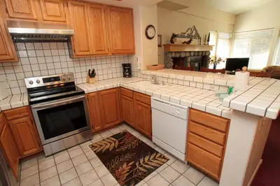 a kitchen with wooden cabinets and a stove top oven at Silver Bear #40 in Mammoth Lakes