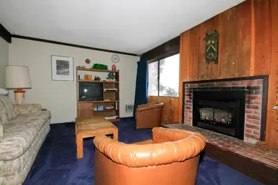 a living room with a couch and a fireplace at Mammoth Ski Racquet Club 129 in Mammoth Lakes