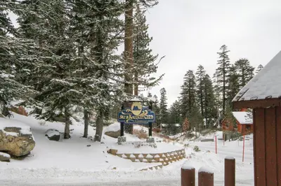 a sign for a ski resort in the snow at Mammoth Ski Racquet Club 129 in Mammoth Lakes