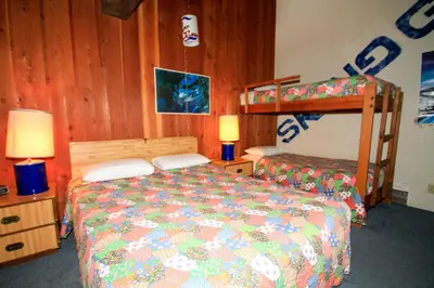 a bedroom with a bed and a bunk bed at Mammoth Ski Racquet Club 129 in Mammoth Lakes