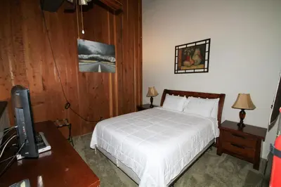 a bedroom with a bed and a desk with a television at Mammoth Ski Racquet Club 120 - Pet Friendly in Mammoth Lakes