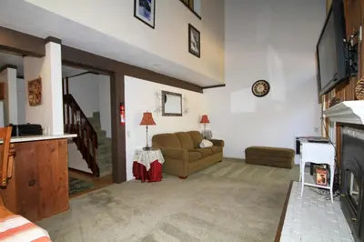 a living room with a couch and a fireplace at Mammoth Ski Racquet Club 120 - Pet Friendly in Mammoth Lakes