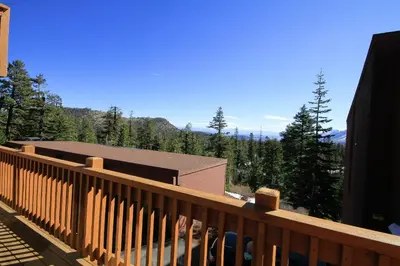 a wooden deck with a view of a mountain at Mammoth Ski Racquet Club 62 - Newly Renovated 2025 in Mammoth Lakes