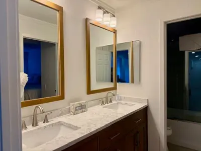 a bathroom with two sinks and two mirrors at Mammoth Ski Racquet Club 62 - Newly Renovated 2025 in Mammoth Lakes