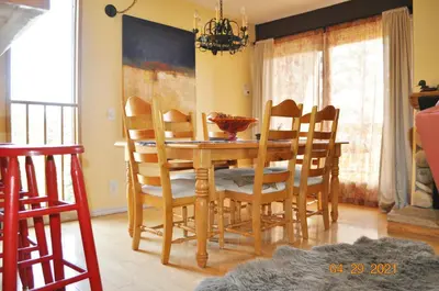 a dining room with a wooden table and chairs at Mammoth Ski Racquet Club 54 in Mammoth Lakes