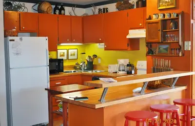 a kitchen with orange cabinets and a white refrigerator at Mammoth Ski Racquet Club 54 in Mammoth Lakes