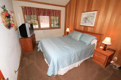 a bedroom with a bed and a television in it at Mountainback 115 3 bedroom loft in Mammoth Lakes