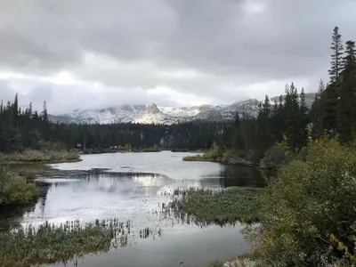 a river with a snow covered mountain in the background at Mountainback 111 in Mammoth Lakes