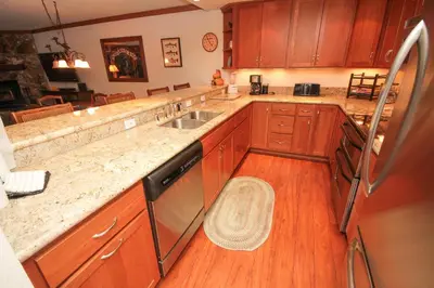 a kitchen with wooden cabinets and a sink at Mountainback 111 in Mammoth Lakes