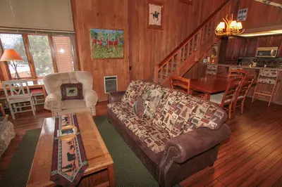 a living room with a couch and a table at Mountainback 105 Loft Den in Mammoth Lakes