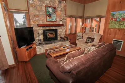 a living room with a couch and a fireplace at Mountainback 105 Loft Den in Mammoth Lakes