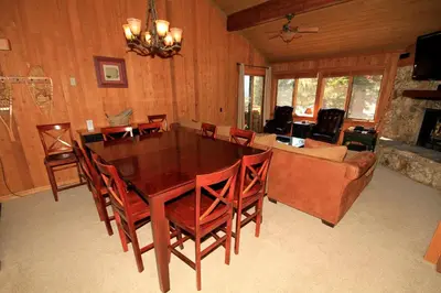 a dining room with a table and chairs and a couch at Mountainback 97 Loft in Mammoth Lakes