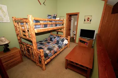 a bedroom with a bunk bed and a television at Mountainback 97 Loft in Mammoth Lakes