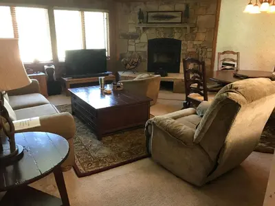 a living room with a couch and a fireplace at Mountainback 94 in Mammoth Lakes