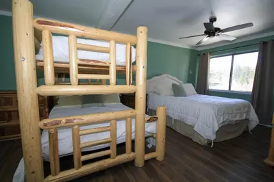 a bedroom with two bunk beds and a ceiling fan at Mammoth Ski Racquet Club 12 - Pet Friendly in Mammoth Lakes