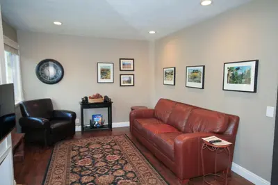 a living room with a leather couch and a chair at Mammoth Ski Racquet Club 38 - Pet ok - Loft in Mammoth Lakes