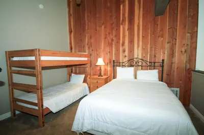 a bedroom with two beds and a bunk bed at Mammoth Ski Racquet Club 38 - Pet ok - Loft in Mammoth Lakes