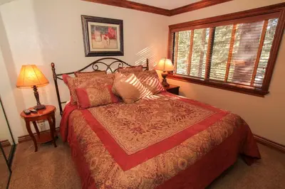 a bedroom with a bed and two lamps and a window at Mammoth Ski Racquet Club 34 in Mammoth Lakes