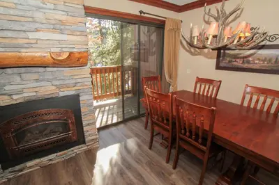 a dining room with a fireplace and a table and chairs at Mammoth Ski Racquet Club 34 in Mammoth Lakes