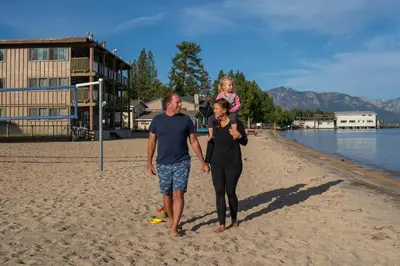 a man and a woman standing on the beach at Tahoe Lakeshore Lodge & Spa in South Lake Tahoe
