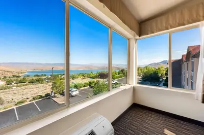 a room with windows with a view of the water at Best Western Topaz Lake Inn in Gardnerville