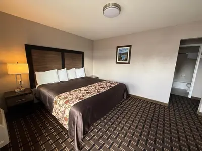 a hotel room with a bed and a lamp at Beverly Lodge in South Lake Tahoe
