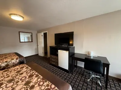 a hotel room with a desk and a bed at Beverly Lodge in South Lake Tahoe