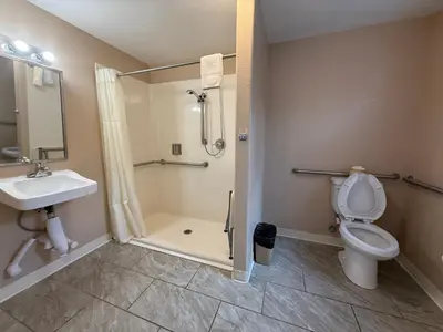 a bathroom with a shower and a toilet and a sink at Beverly Lodge in South Lake Tahoe