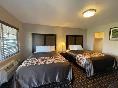 a hotel room with two beds and a window at Beverly Lodge in South Lake Tahoe