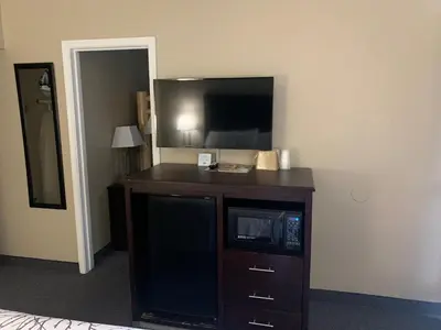 a hotel room with a microwave and a television at Black Jack Inn in South Lake Tahoe